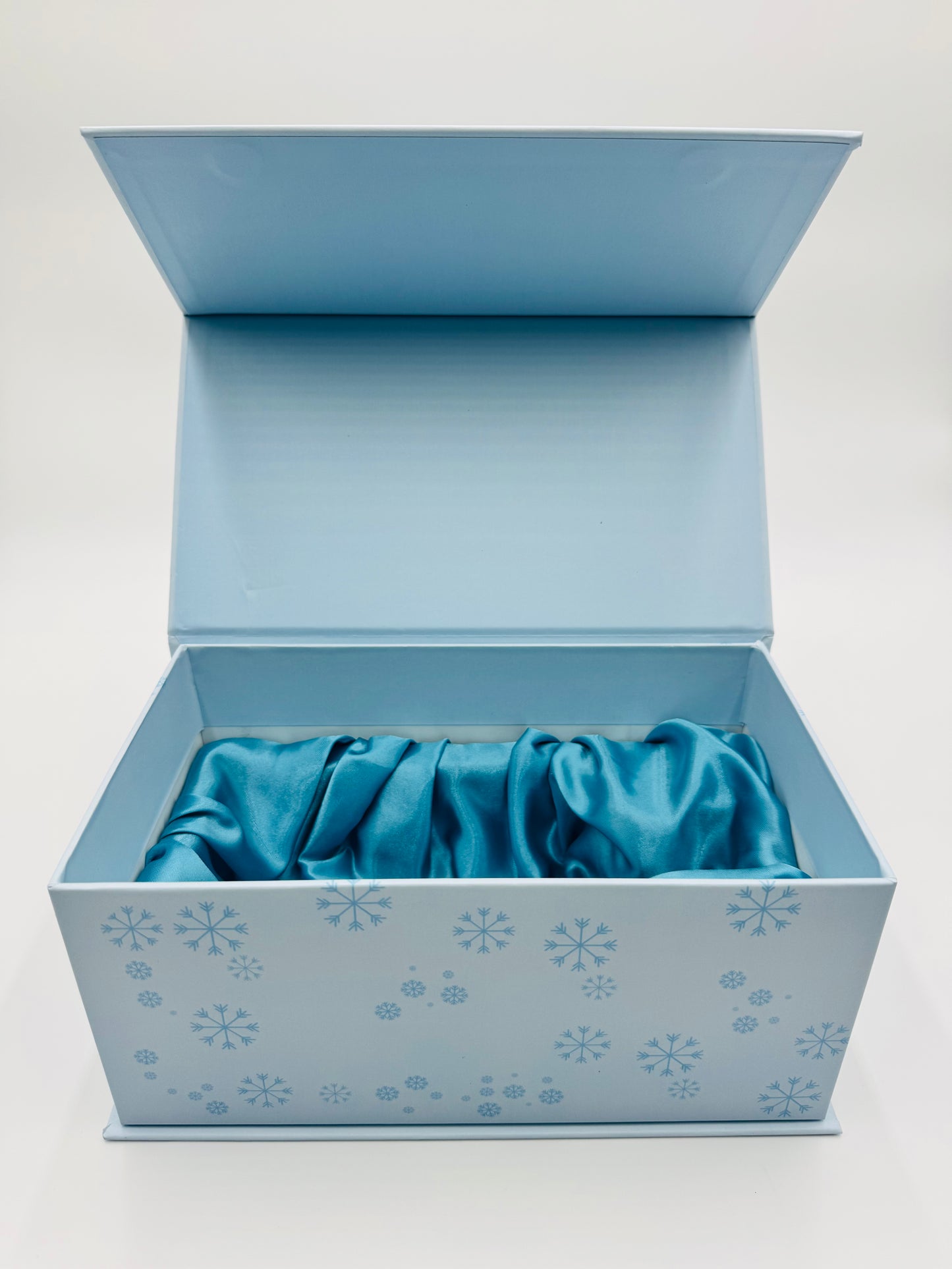 Kreyól Twist Gift box with a blue fabric item inside on a white background