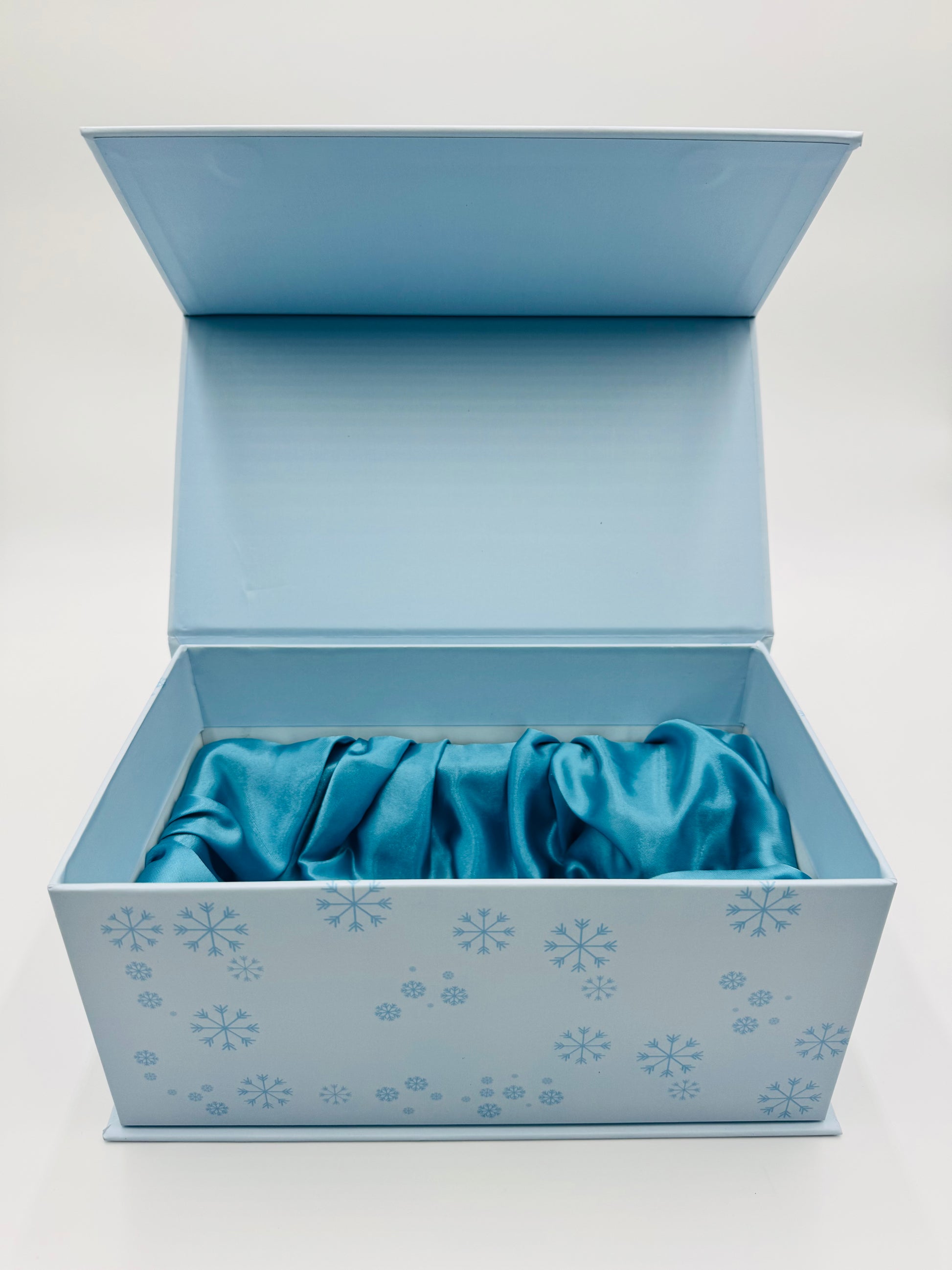 Kreyól Twist Gift box with a blue fabric item inside on a white background