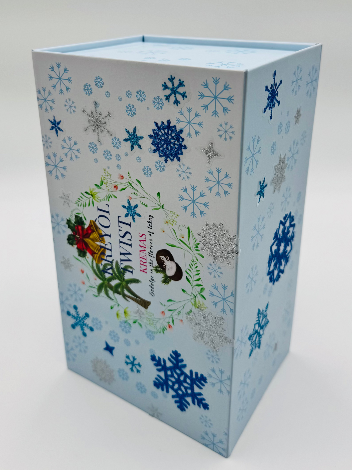 Decorative Kreyol Twist box with snowflake patterns and illustrations on a light blue background