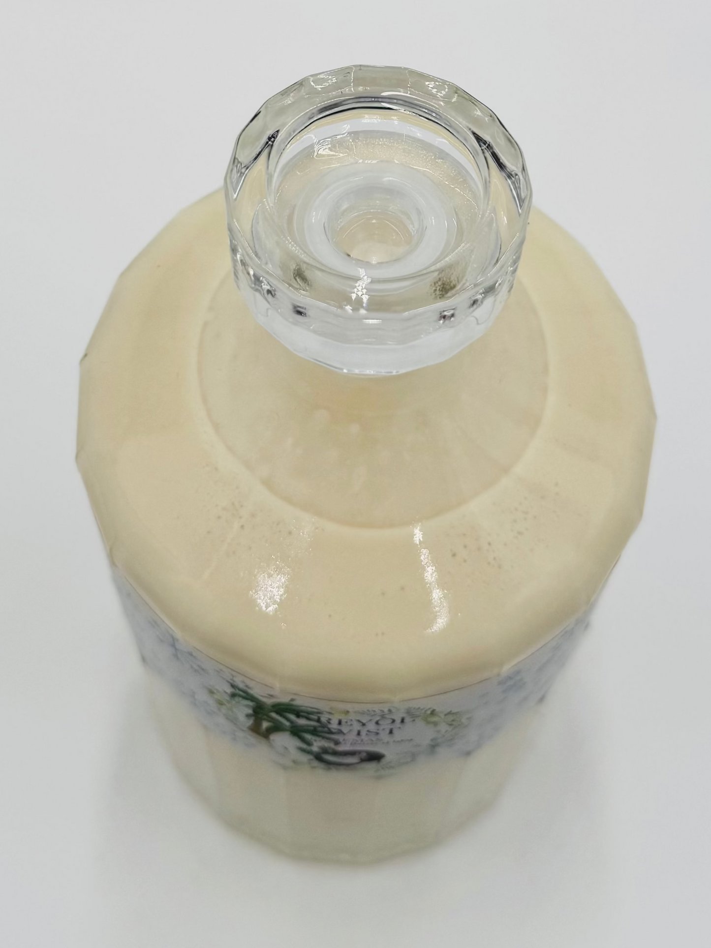 Kremas bottle with a clear glass cap on a white background