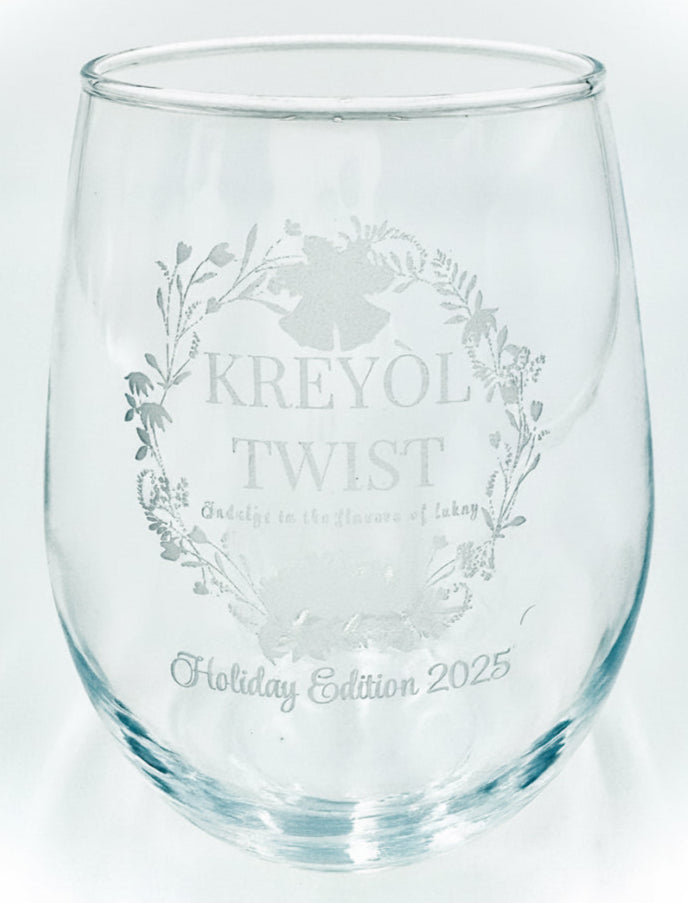 Clear glass wine glass with 'Kreyol Twist' etching on a white background